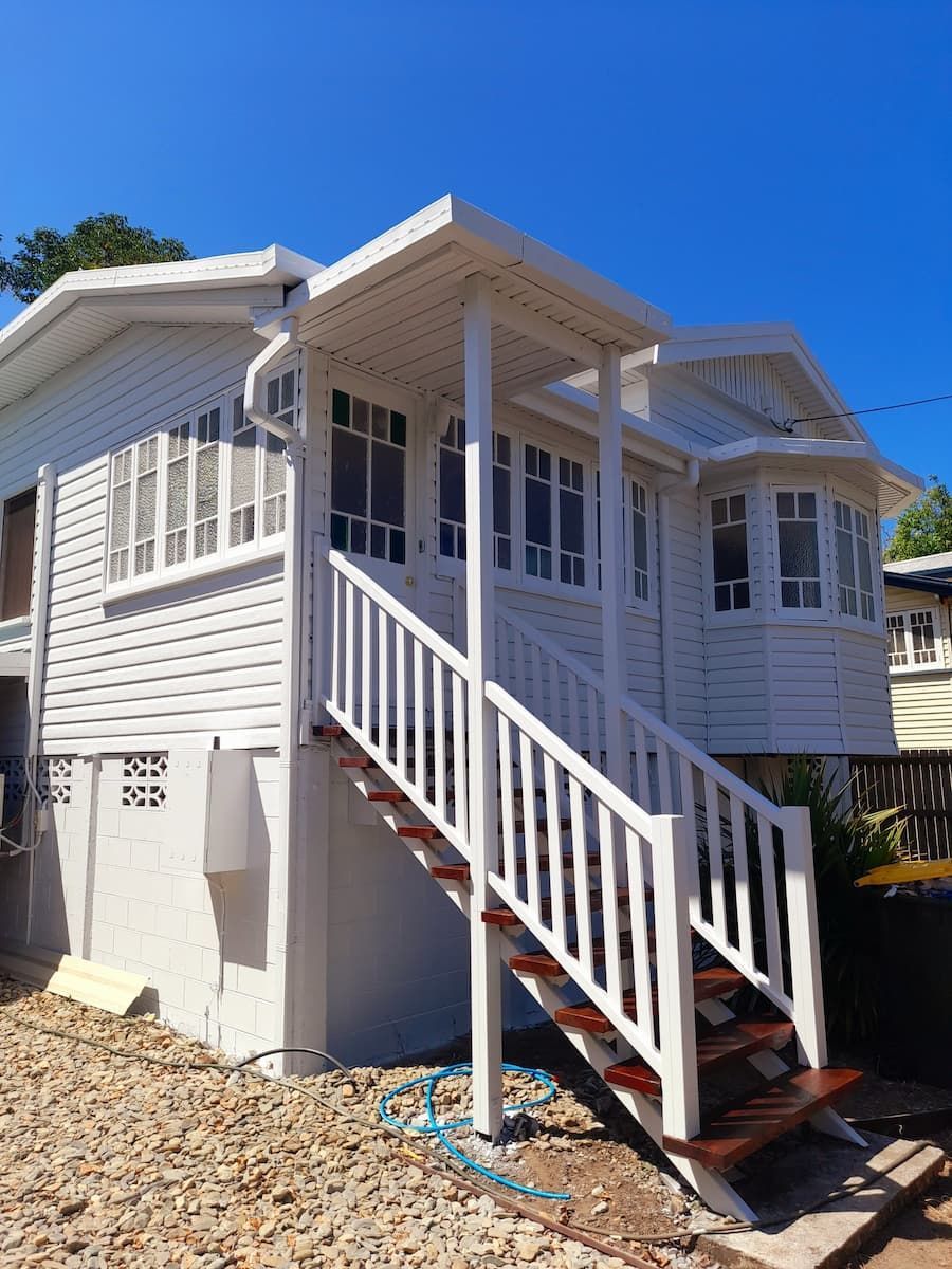 A White House With Stairs Leading Up To The Second Floor — Kiwi Painter In Mooroobool, QLD