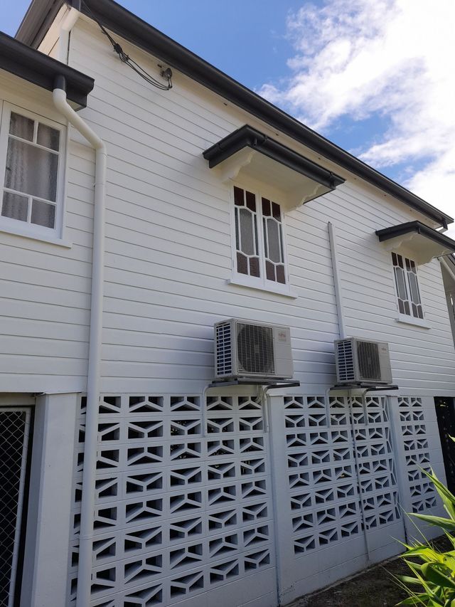 A Before And After Picture Of A Garage With A Blue Door — Kiwi Painter In Mooroobool, QLD