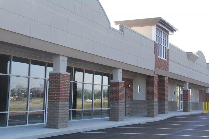 A building with a lot of windows and brick pillars