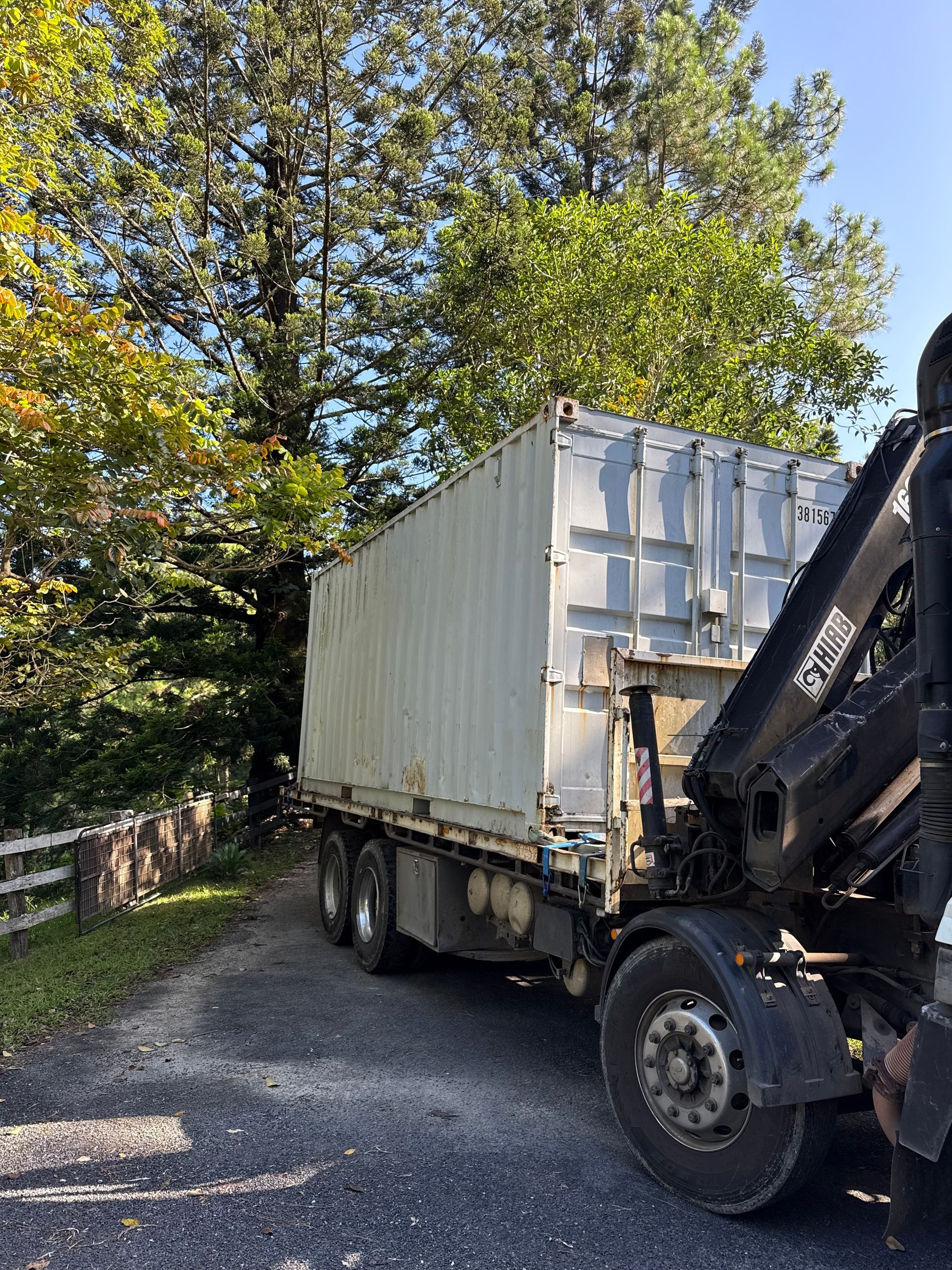 A White Container is Being Transported on The Back of a Truck — Brodees Crane Trucks in Ballina, NSW