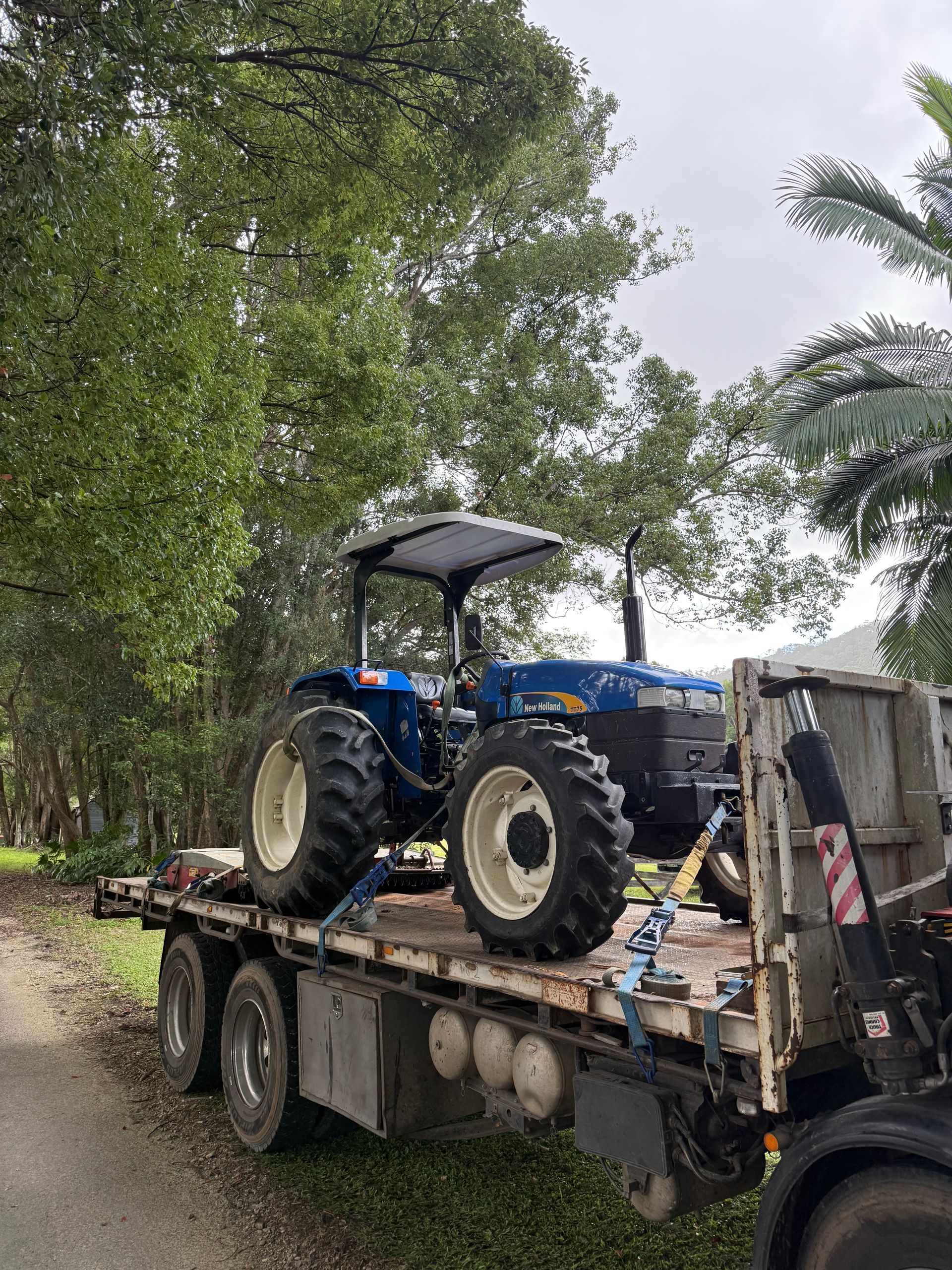 A Blue Tractor is Attached to a Trailer— Brodees Crane Trucks in Brisbane, NSW