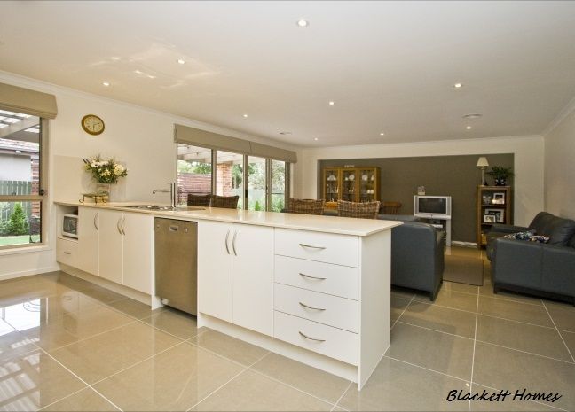 Small, White Kitchen With a Window and Upper Cabinets — Rectified Edge Tiling & Bathroom Renovations in Bungendore, NSW