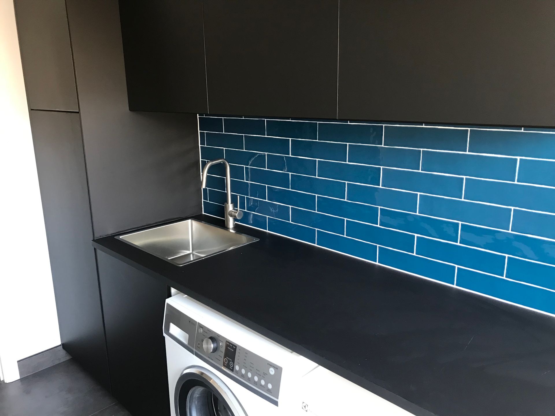 Laundry Room With a Washing Machine — Rectified Edge Tiling & Bathroom Renovations in Queanbeyan, NSW
