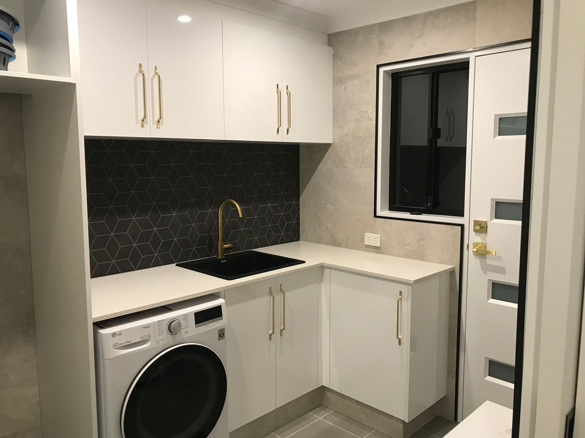 Laundry Room With White Cabinets, Gold Hardware — Rectified Edge Tiling & Bathroom Renovations in Jamison Centre, ACT