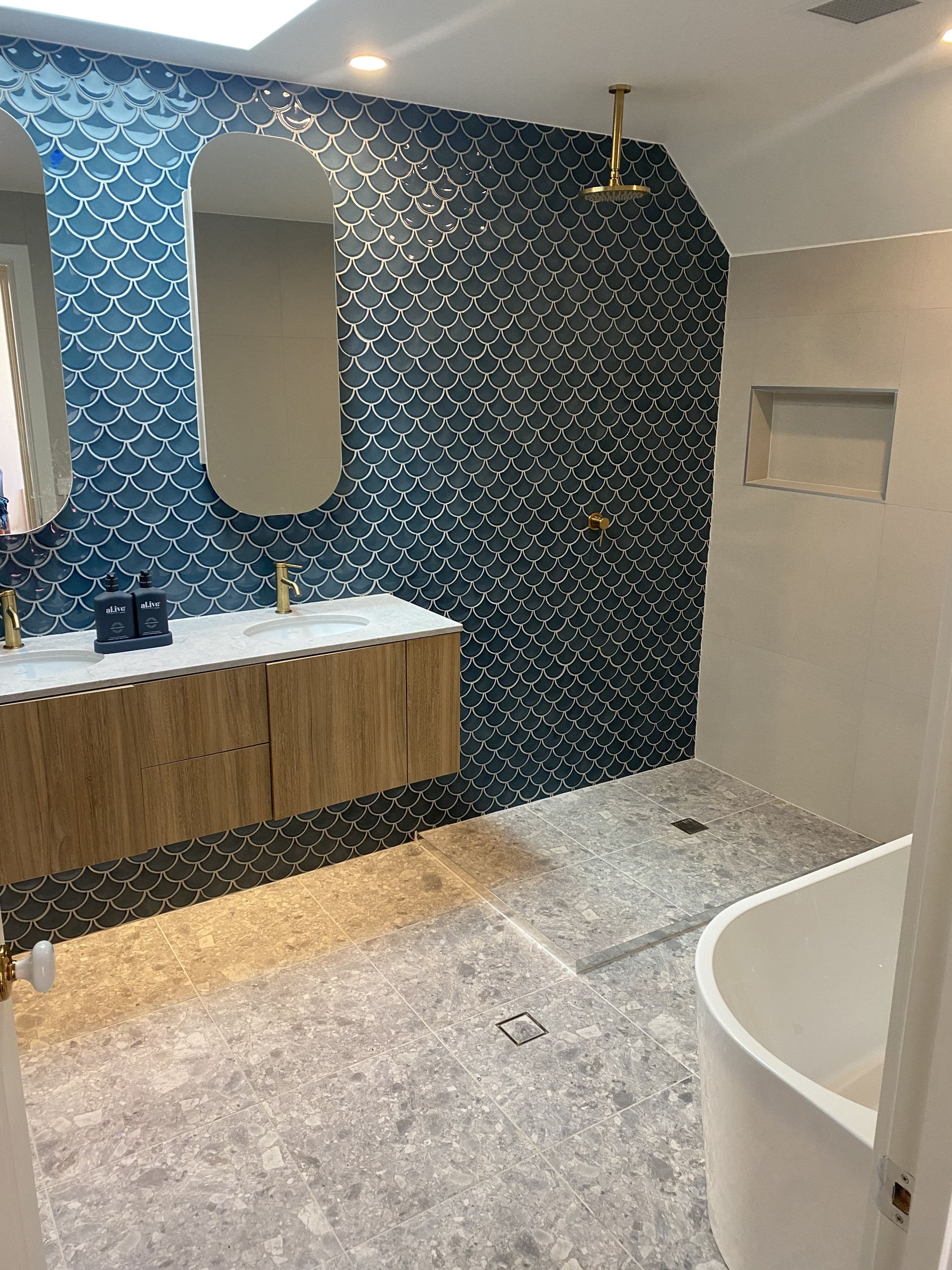 Modern Bathroom With Blue Tile Accent Wall — Rectified Edge Tiling & Bathroom Renovations in Jamison Centre, ACT