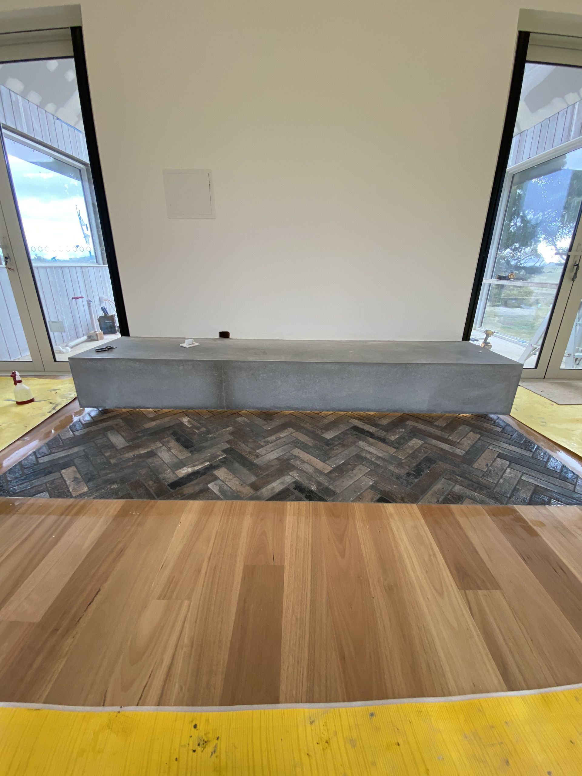 A Modern Room Featuring a Concrete Bench — Rectified Edge Tiling & Bathroom Renovations in Jamison Centre, ACT