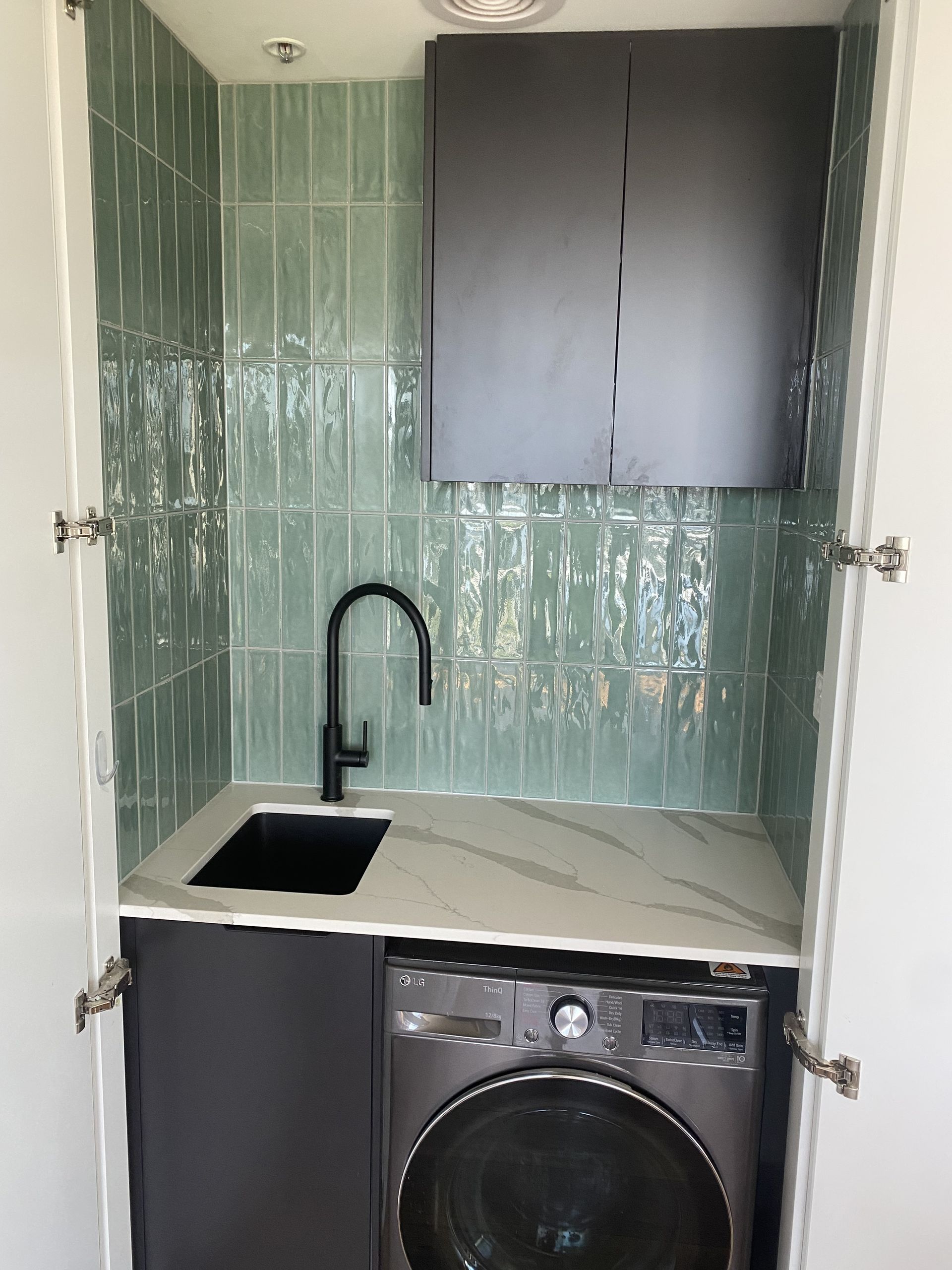 Laundry Room With Green Tiled Backsplash — Rectified Edge Tiling & Bathroom Renovations in Jamison Centre, ACT