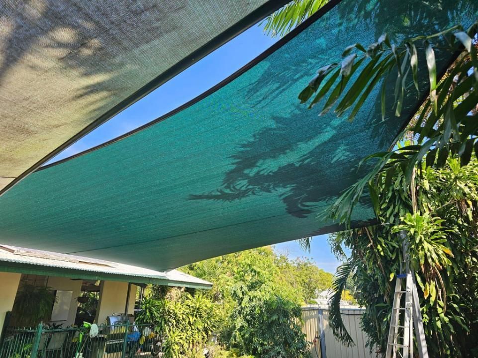 A Green Shade Sail Is Covering The Roof Of A House — All Car Upholstery In Pinelands, NT