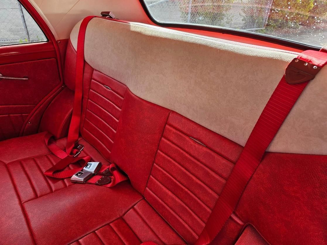 The Back Seat Of A Red Car With Red Seat Belts — All Car Upholstery In Pinelands, NT