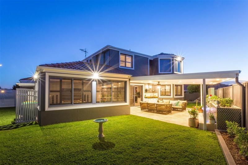 A Large House With a Garage and a Driveway in Front of It — Commercial Painting Group in Kiama, NSW