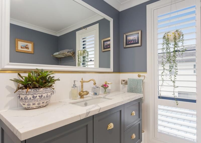 A bathroom with grey cupboards and walls — Commercial Painting Group in Goulburn, NSW