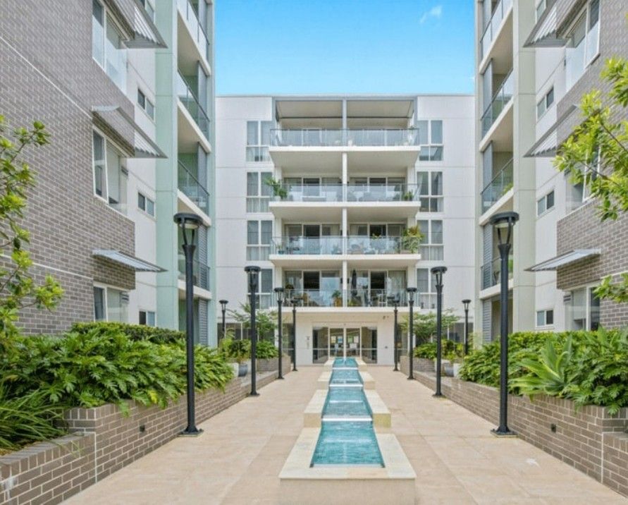 The entrance of an apartment block and a pool in the middle — Commercial Painting Group in Kembla Grange, NSW