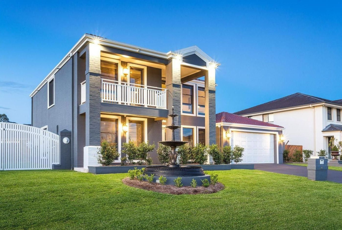 A Large House With a Fountain in Front of It — Commercial Painting Group in Southern Highlands, NSW