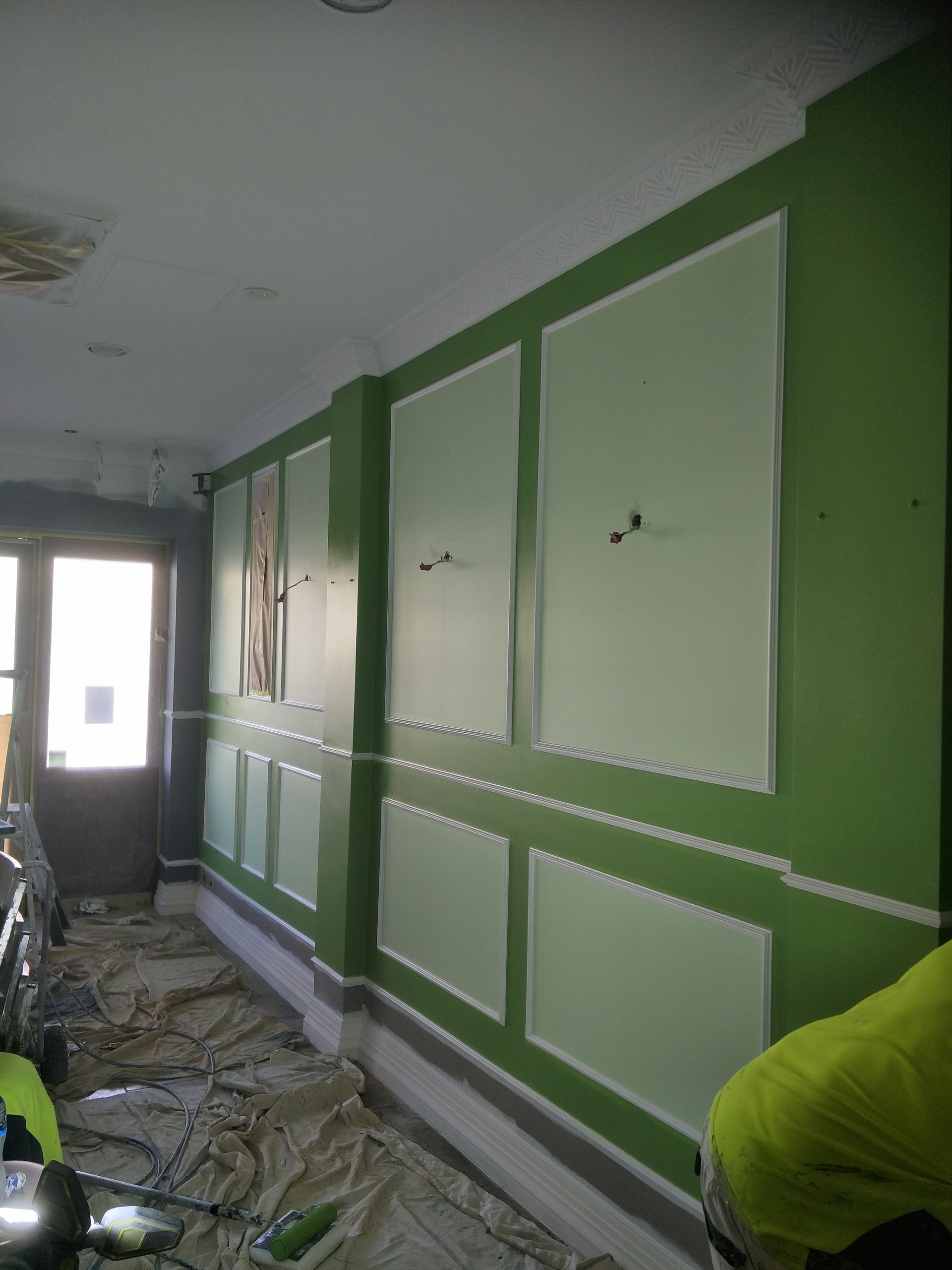 A green wall with white squares  — Commercial Painting Group in Thirroul, NSW