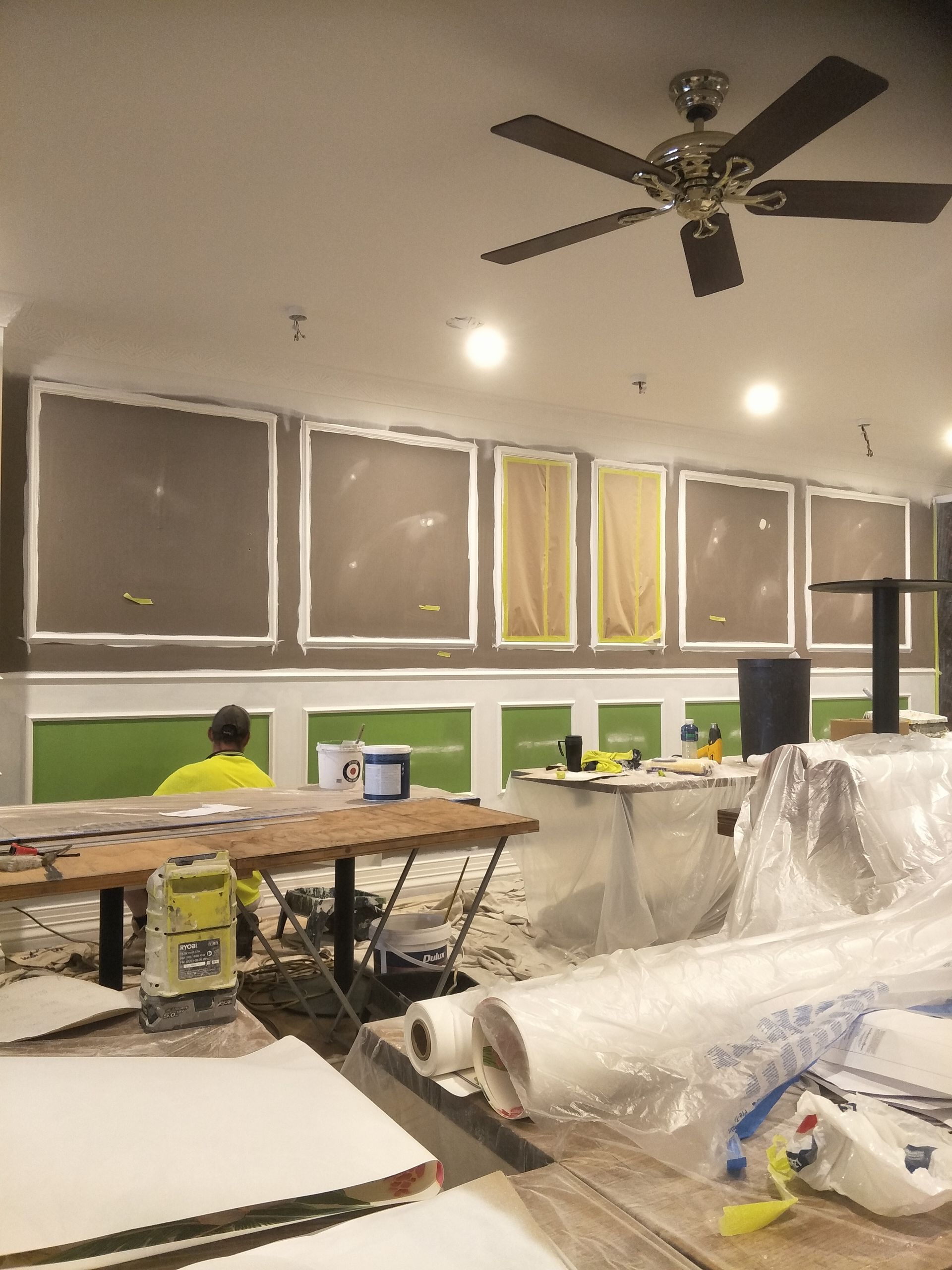 A man is working on painting a wall — Commercial Painting Group in Central West, NSW