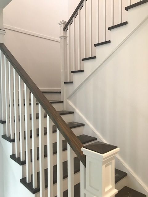 A Hallway With Stairs Leading Up to the Second Floor of a Building — Commercial Painting Group in Kiama, NSW