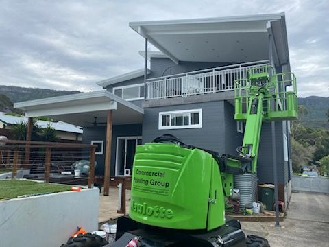 A grey house with a green crane — Commercial Painting Group in Southern Highlands, NSW