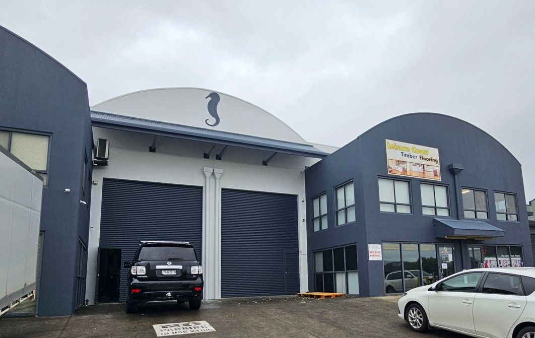 A shop front with navy walls and a car parked — Commercial Painting Group in Goulburn, NSW