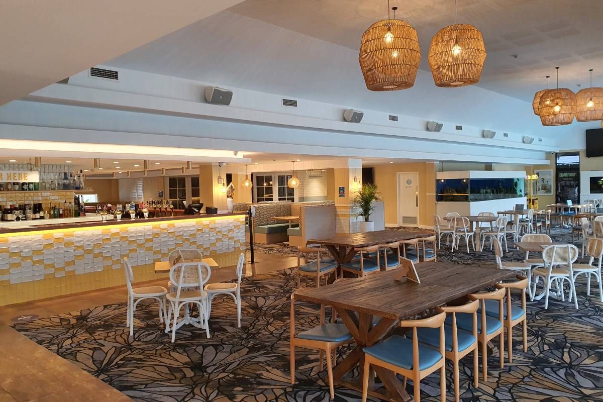 A Restaurant With Tables and Chairs and a Bar  — Commercial Painting Group in Thirroul, NSW