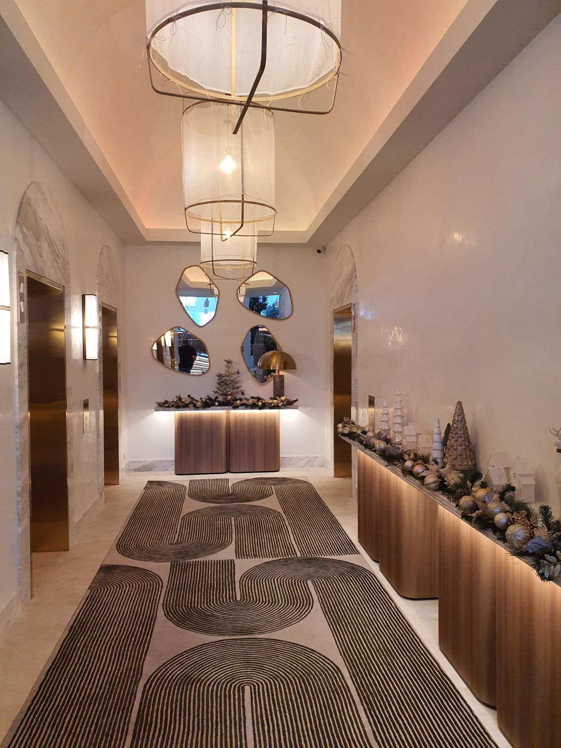 A hotel lobby with patterned carpets and mirrors on the wall — Commercial Painting Group in Kembla Grange, NSW