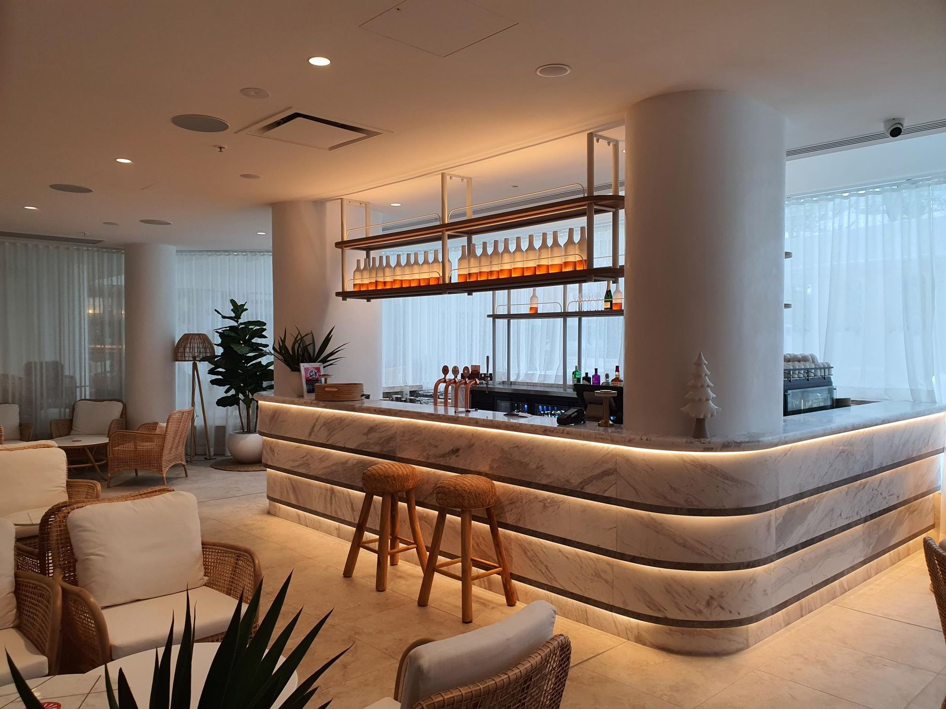 A restaurant bar with stools and couches — Commercial Painting Group in Kembla Grange, NSW