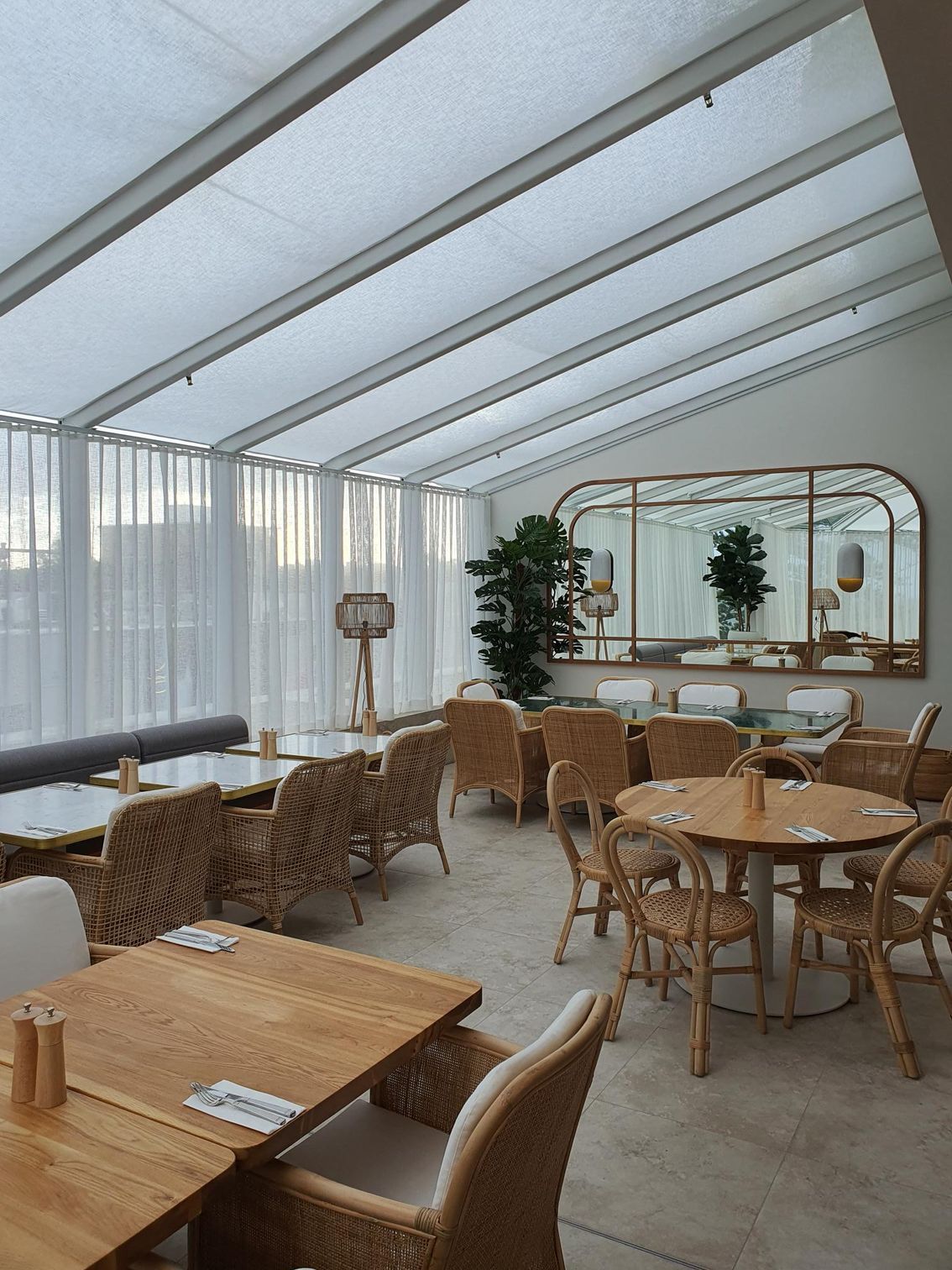 A restaurant with tables and cane chairs — Commercial Painting Group in Kembla Grange, NSW
