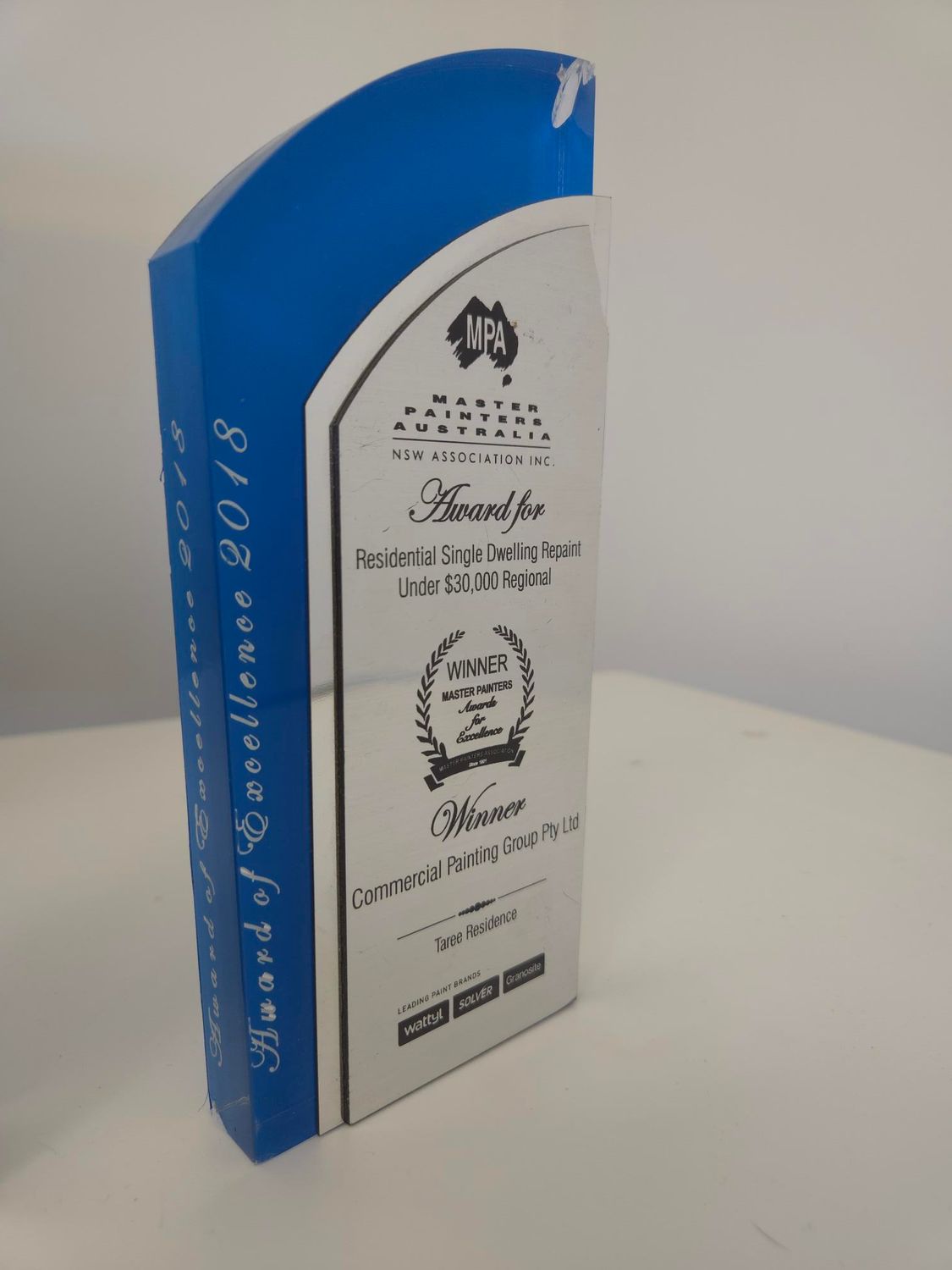 A blue and white trophy sitting on a table — Commercial Painting Group in Kembla Grange, NSW