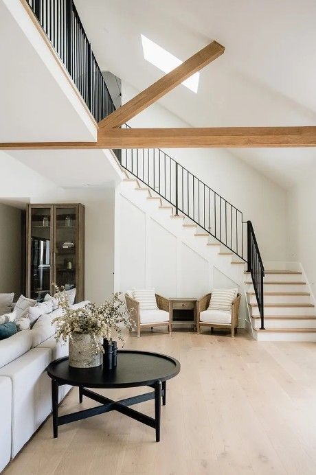 A room with a couch, small black table and a staircase — Commercial Painting Group in Kembla Grange, NSW