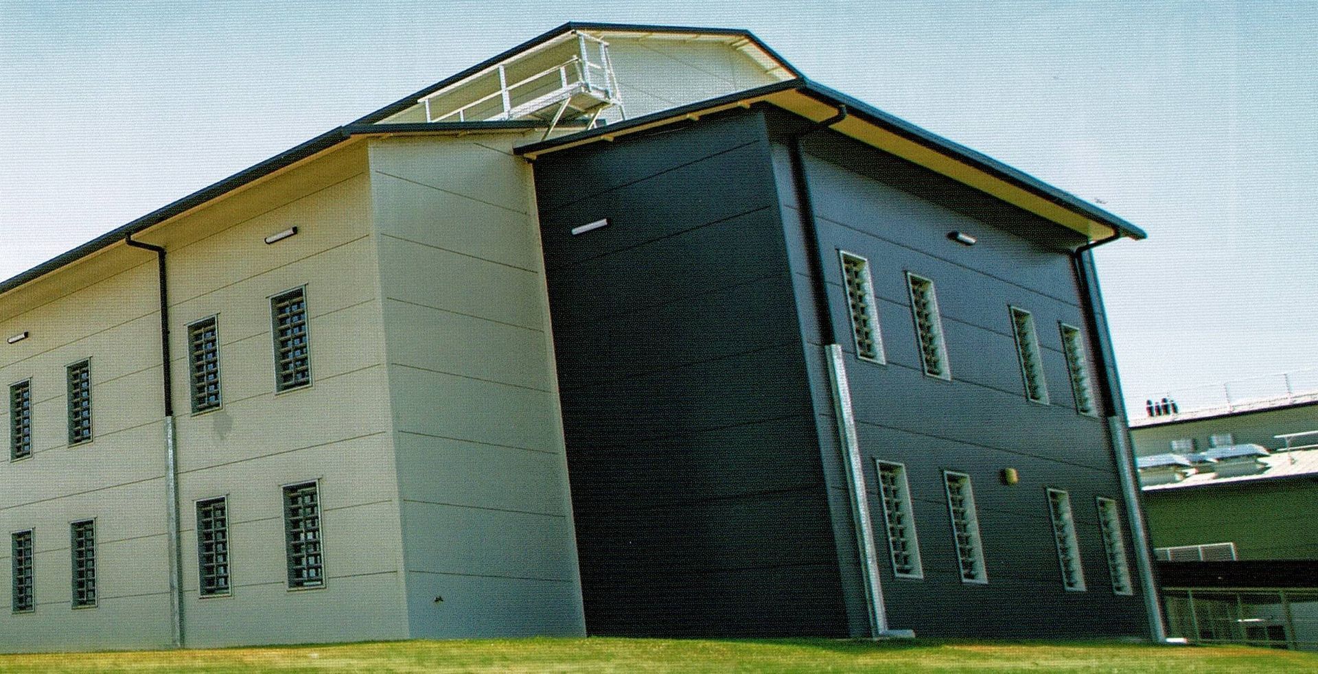 A building with dark paint — Commercial Painting Group in Kembla Grange, NSW