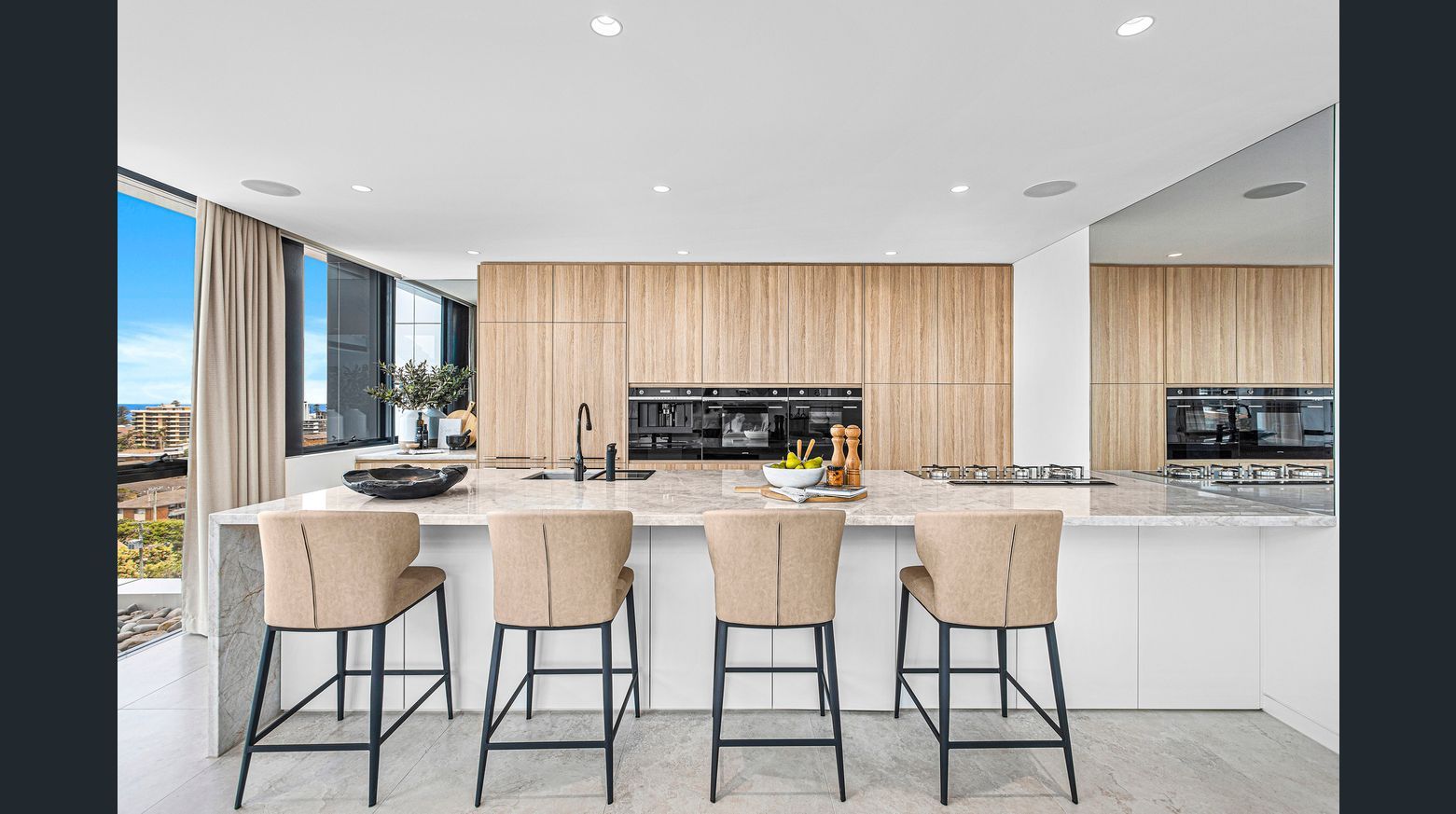 A kitchen with wooden cupboards and four chairs — Commercial Painting Group in Kembla Grange, NSW
