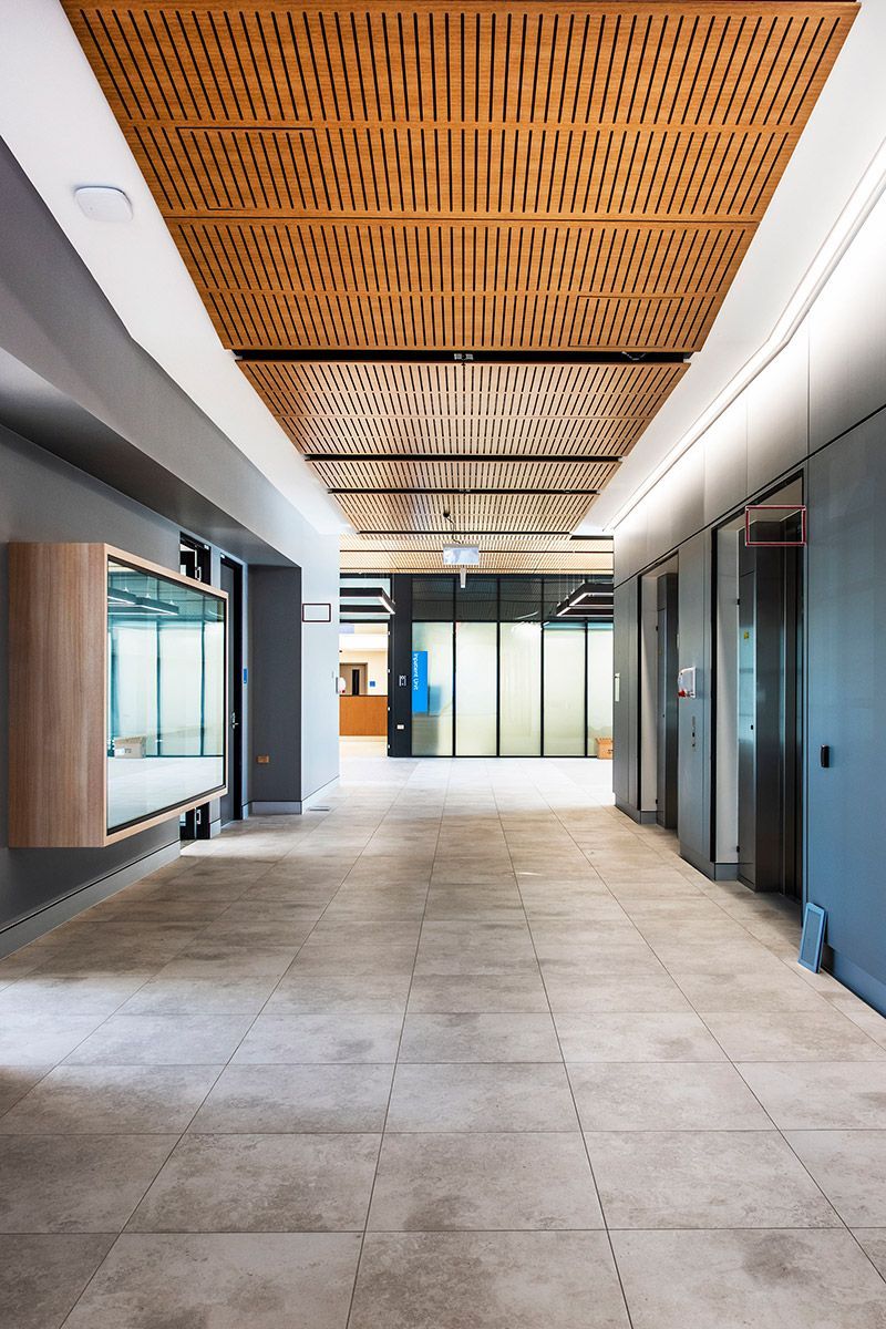 A lobby corridor with grey walls and windows — Commercial Painting Group in Kembla Grange, NSW