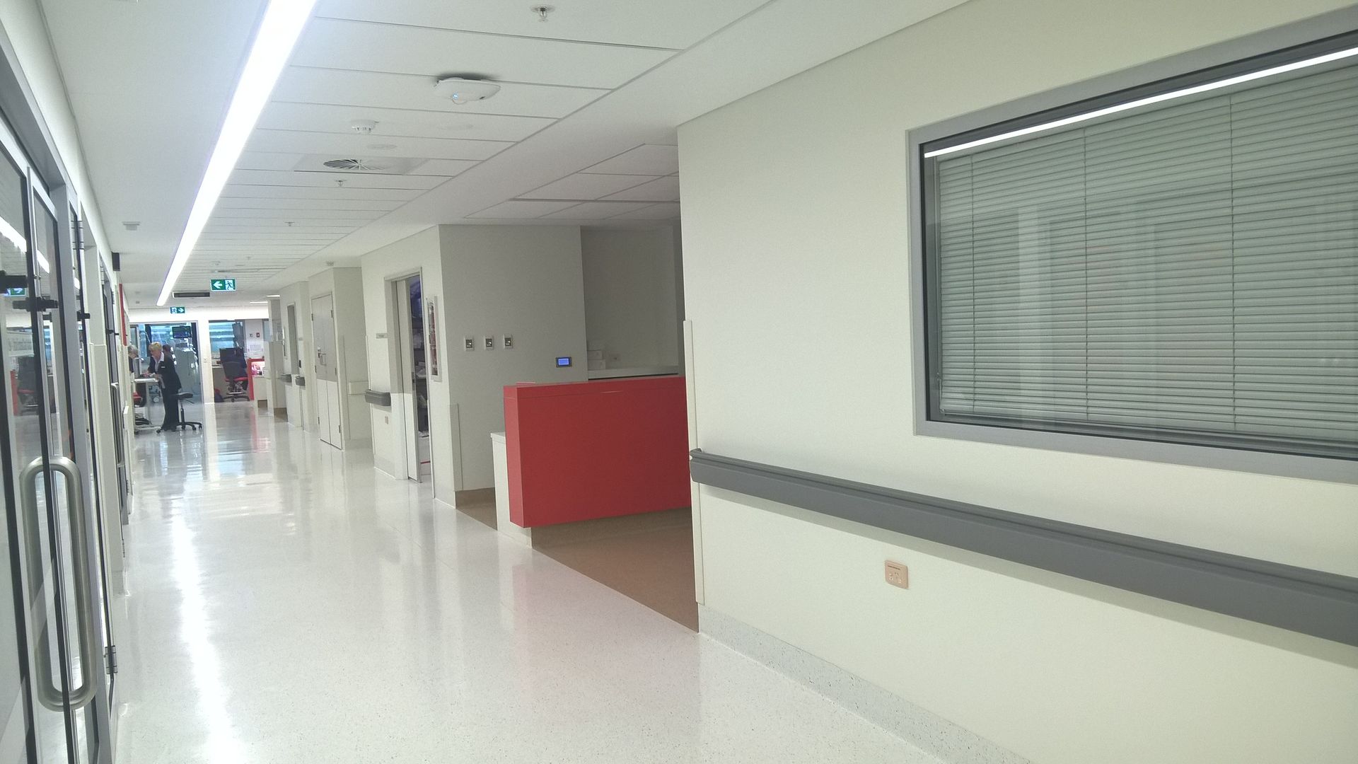 A hospital hallway with white walls — Commercial Painting Group in Kembla Grange, NSW