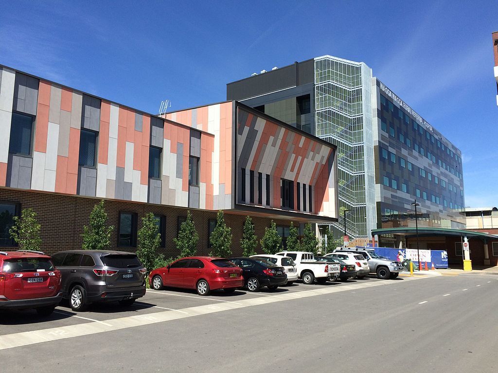 A hospital building with cars parked on the street in front — Commercial Painting Group in Kembla Grange, NSW