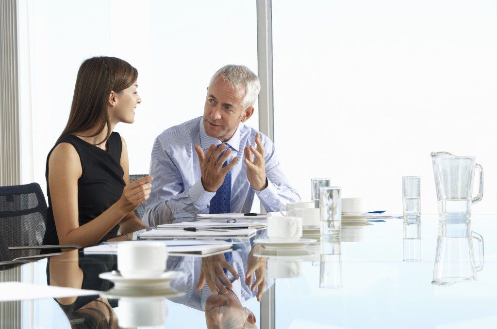 man and woman talking at a table