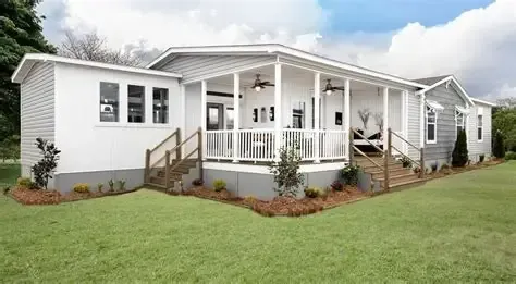 A white house with a porch and a chimney 
