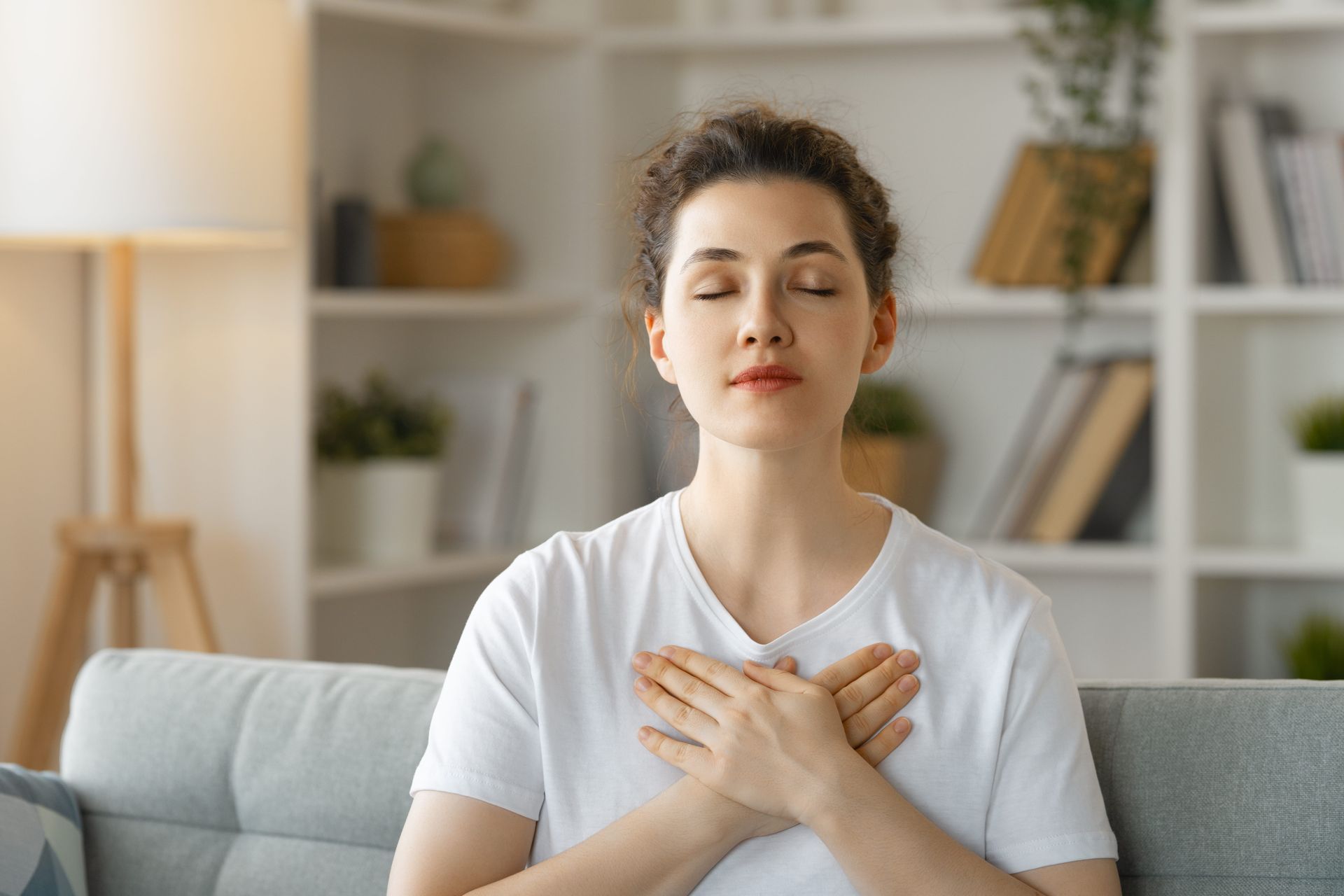 Person practicing paced breathing as part of DBT TIPP skill for emotional regulation during distress