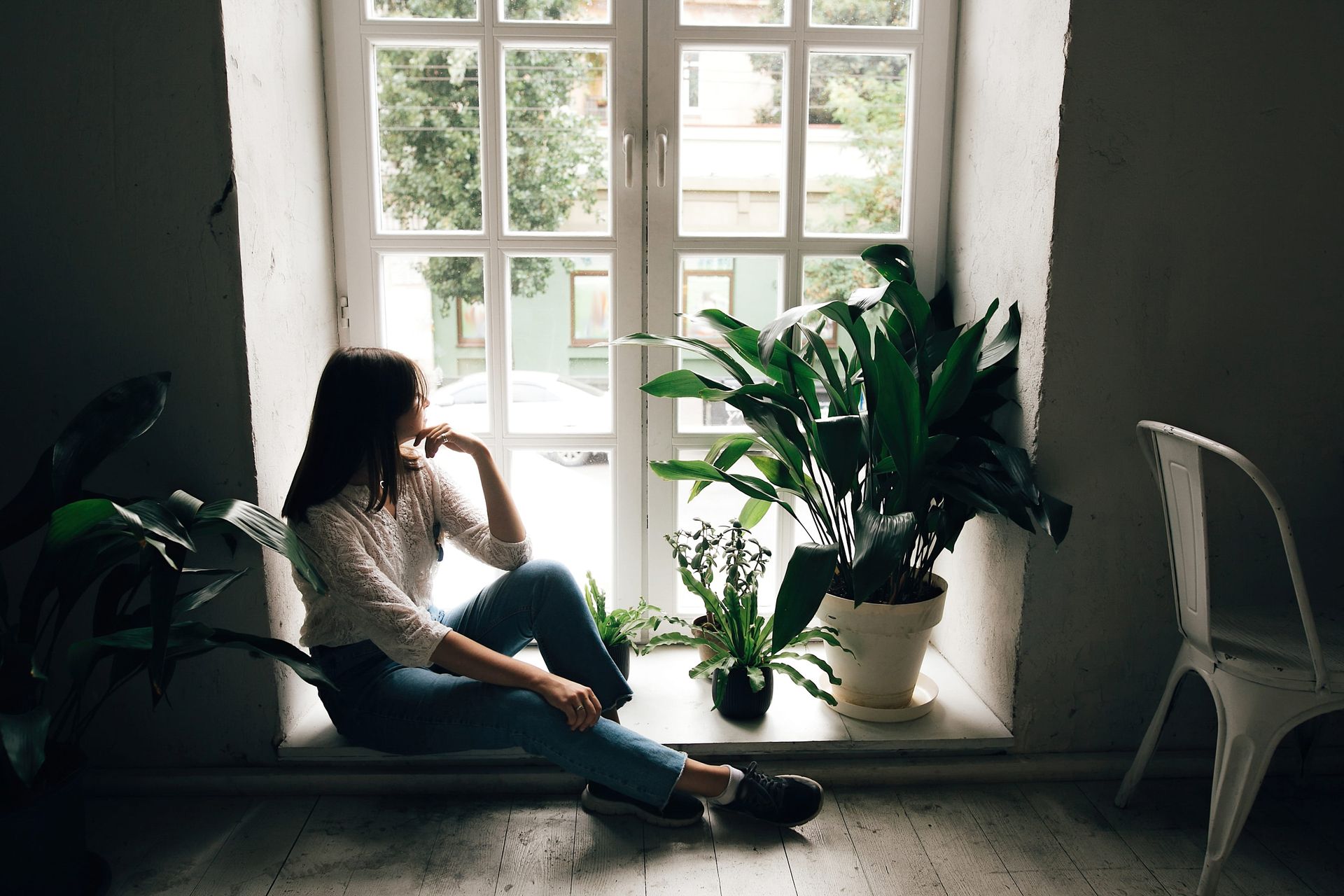 Person sitting quietly by a window, representing DBT for depression treatment at Minisink Psychology