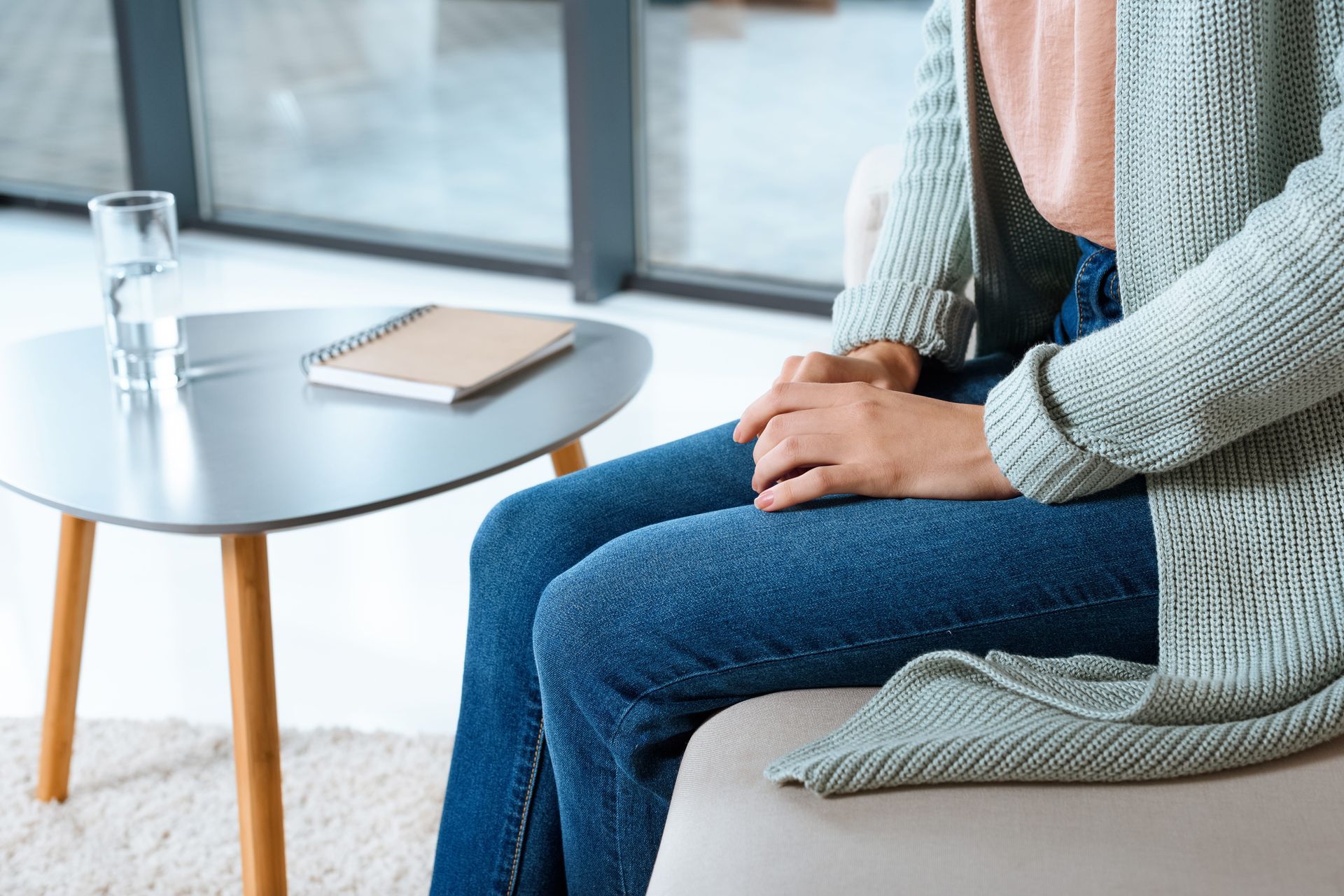 Adult sitting calmly with therapist during DBT therapy session for emotion regulation