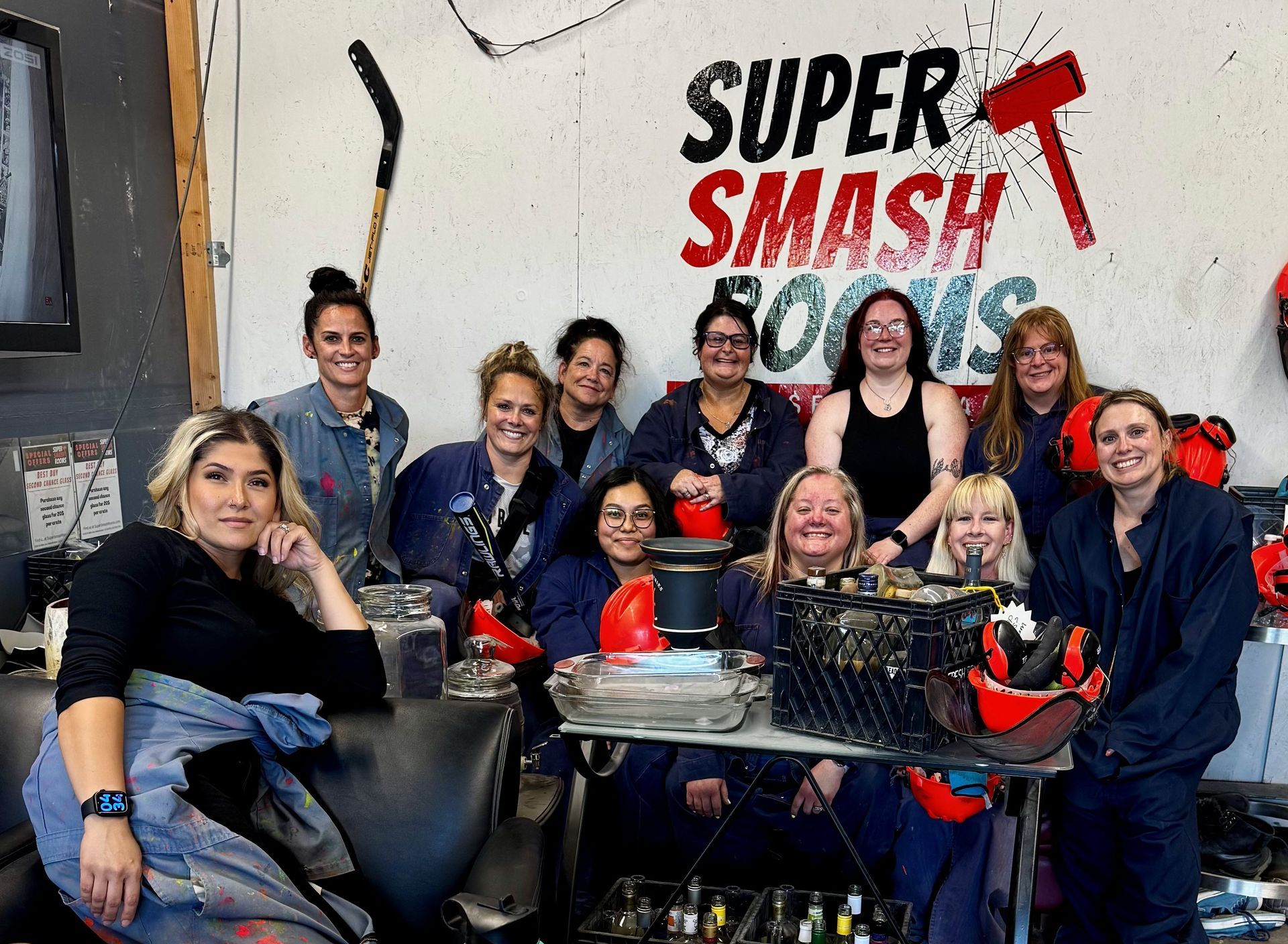 Group posing with smash cakes and a “Super Smash” sign in a party room