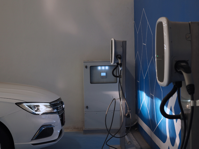 a white car is plugged into a charging station