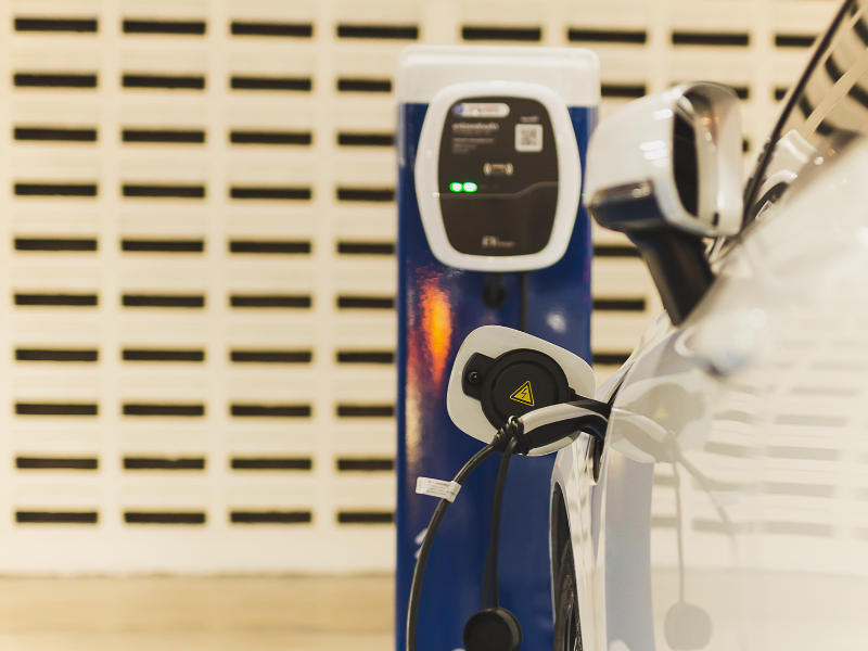 an electric car is being charged at a charging station