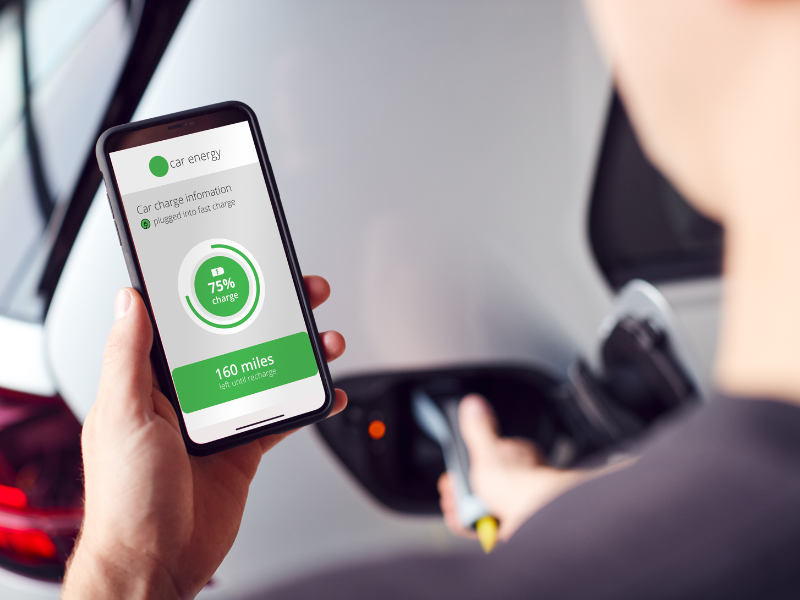 a person holding a cell phone that says car energy on the screen