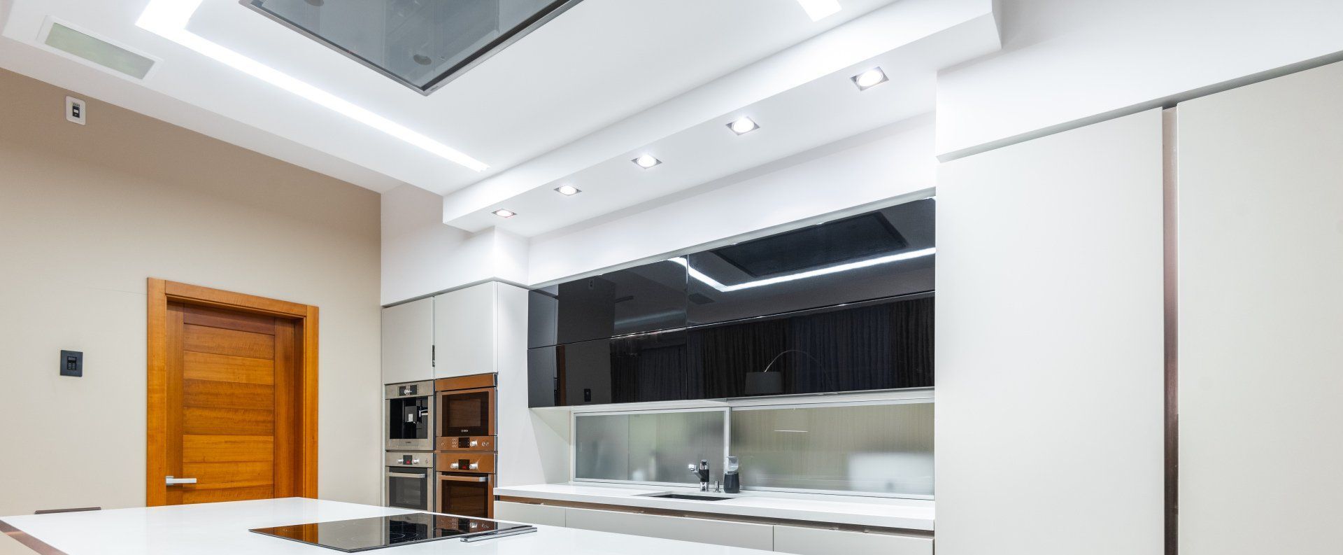 A kitchen with multiple electrical appliances