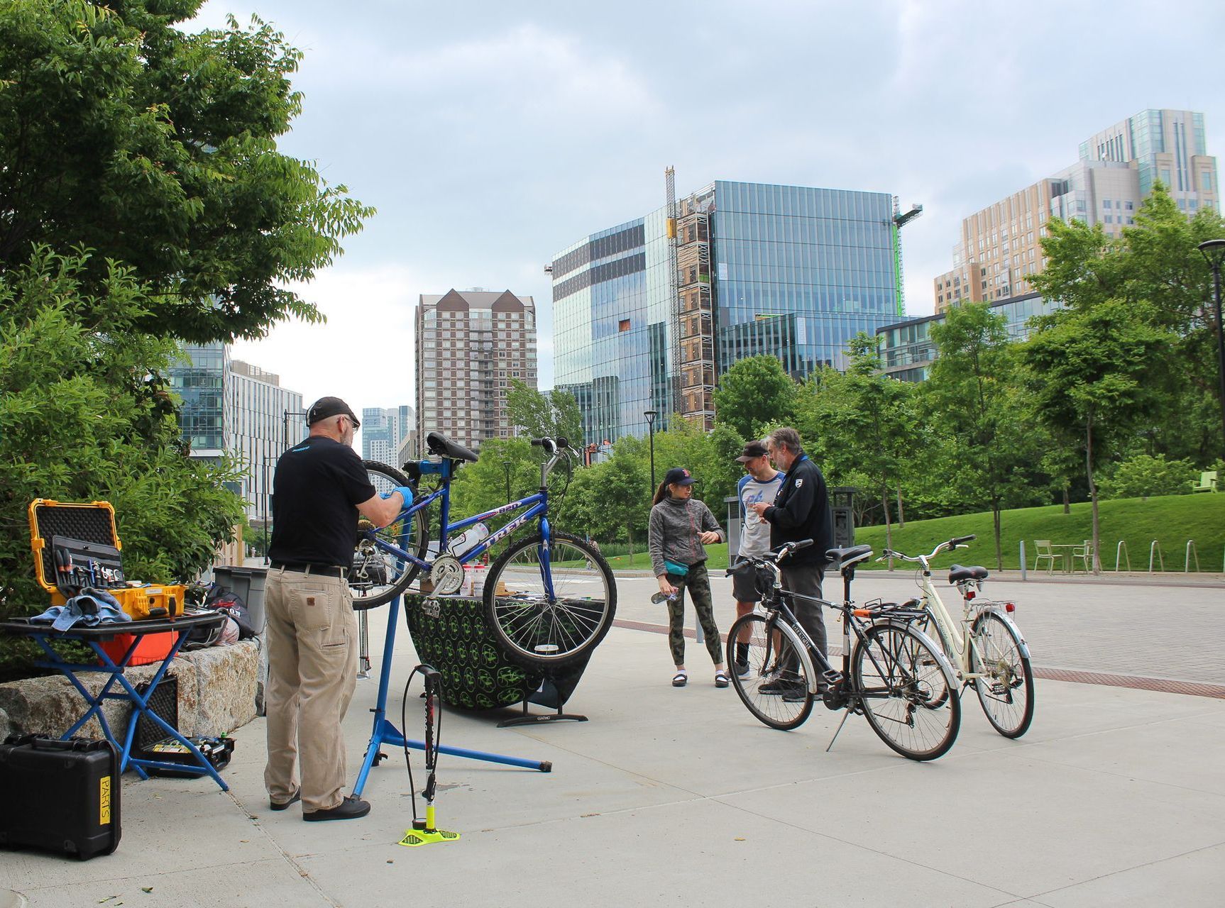 bike mechanic working on an employee's bike with cambridge skyline