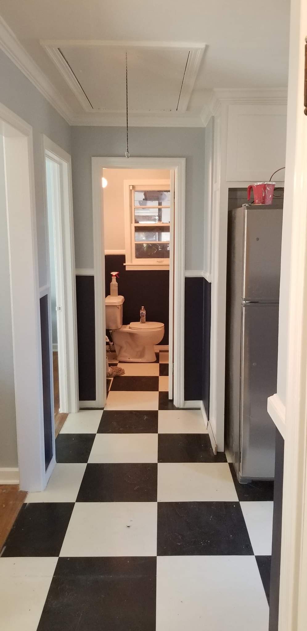 A black and white checkered floor in a hallway