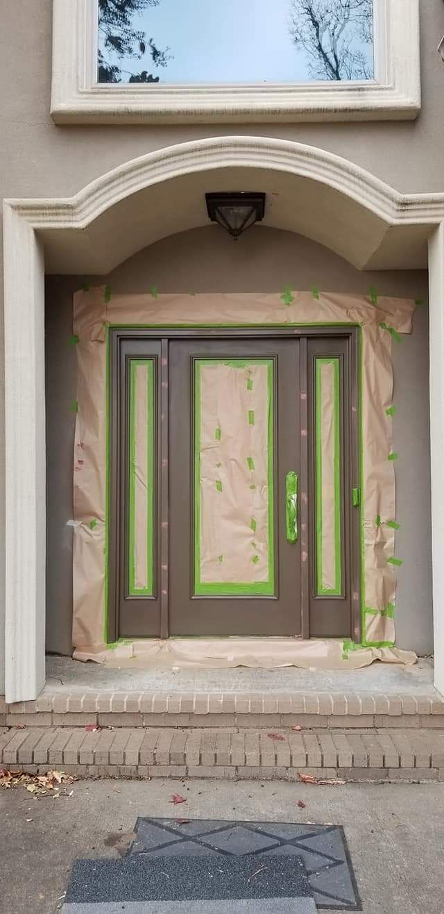The front door of a house is being painted.