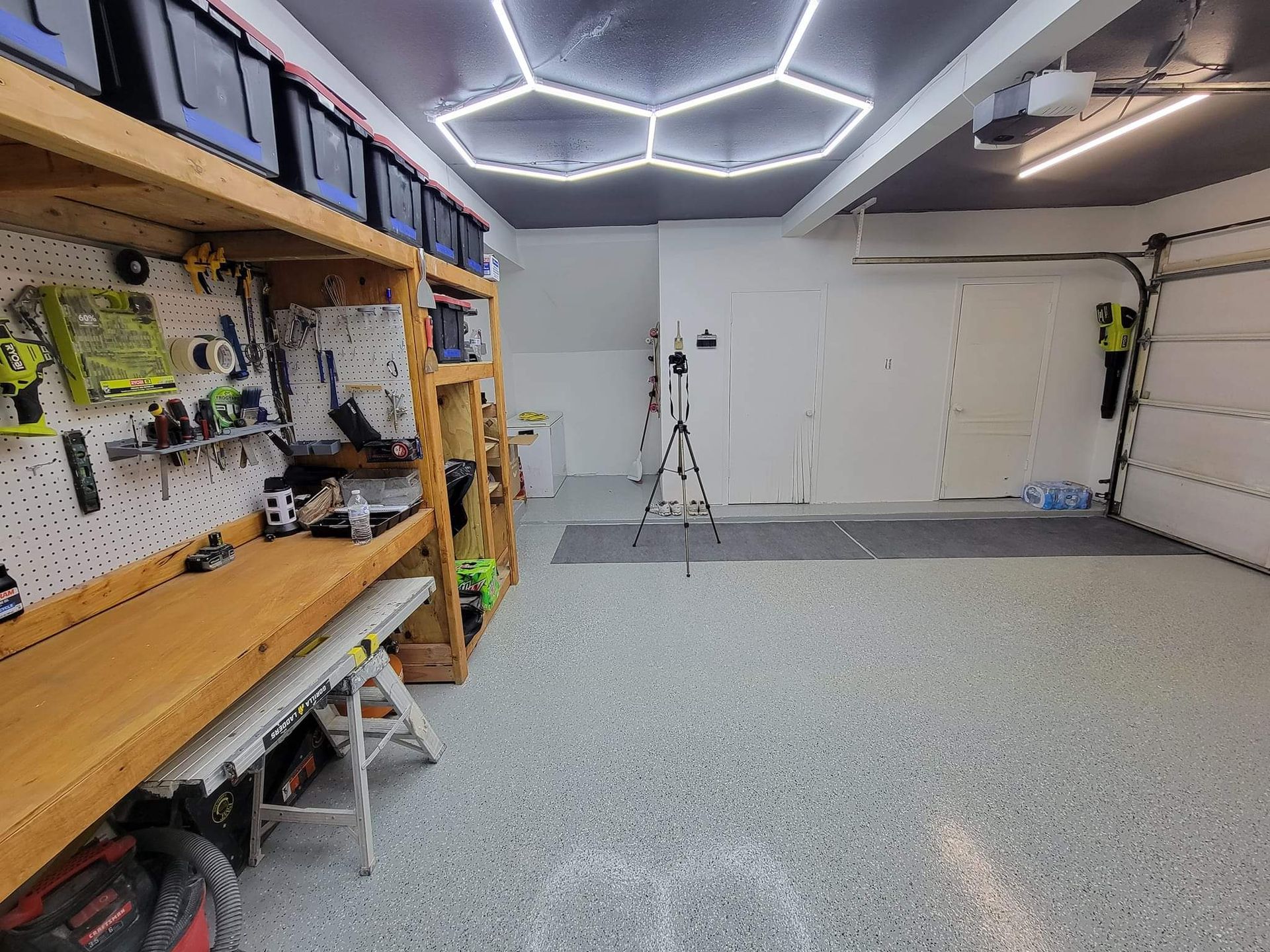 A garage filled with lots of tools and a ladder.