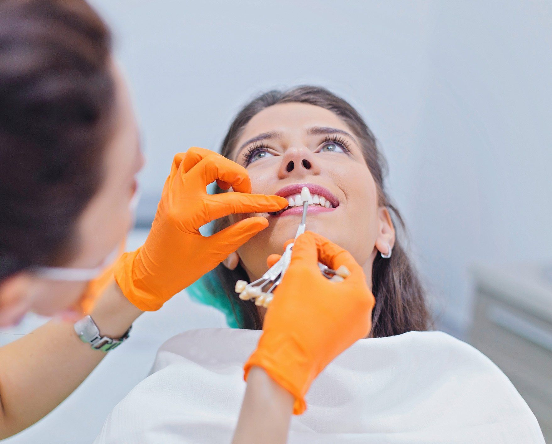 Dentist choosing the right colour of teeth | Ringwood, VIC | Abstract Arch Denture Clinic