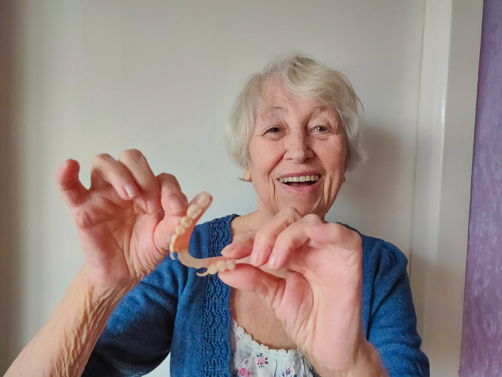 Dentures in senior female hand | Ringwood, VIC | Abstract Arch Denture Clinic