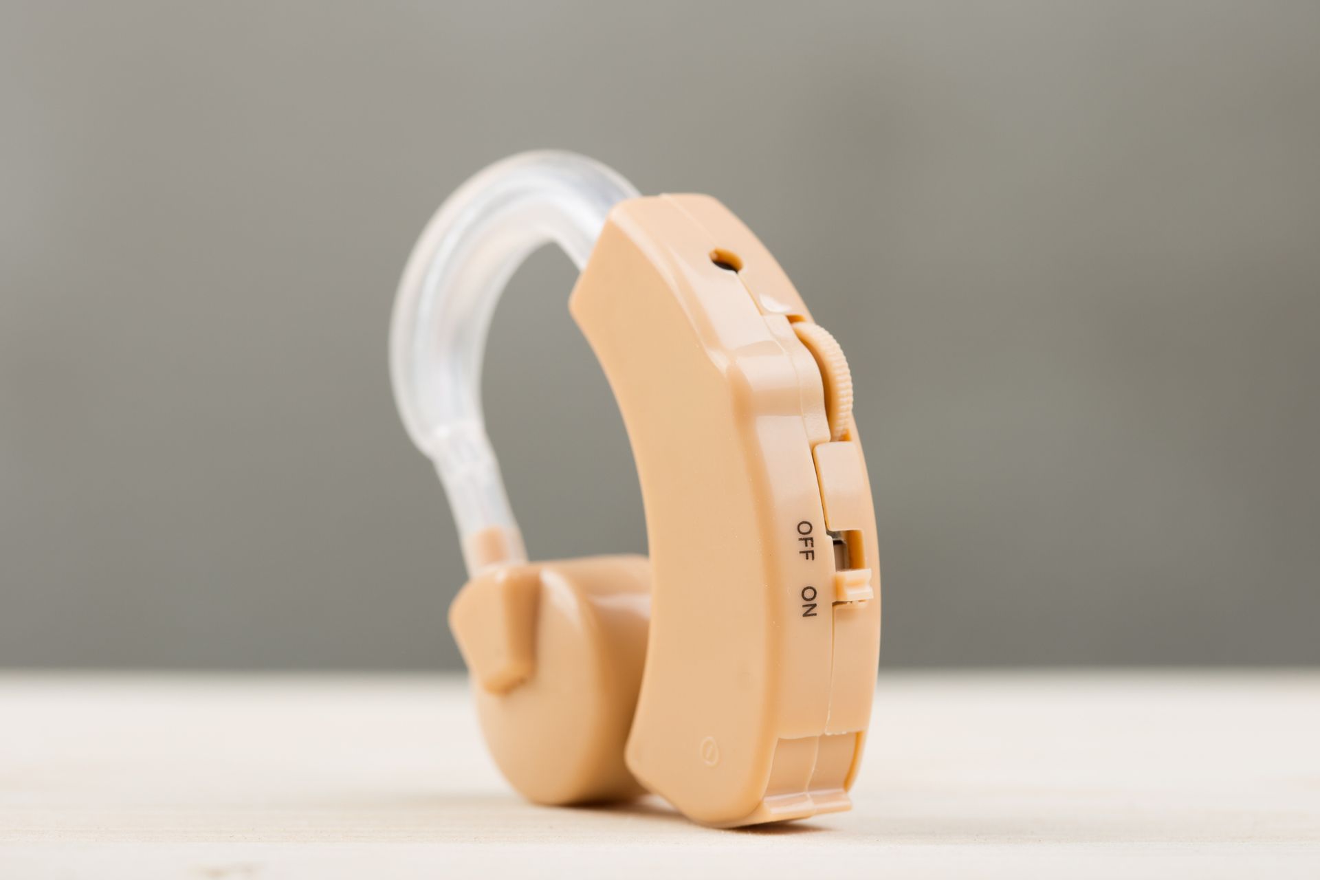 A woman wearing a hearing aid in her left ear.